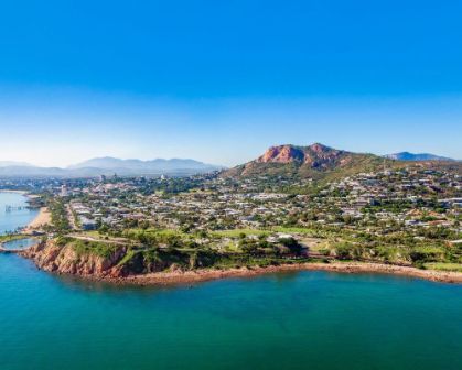 Picture of Aerial view of Townsville coastline with rocky shore, urban area, and Castle Hill in the background.